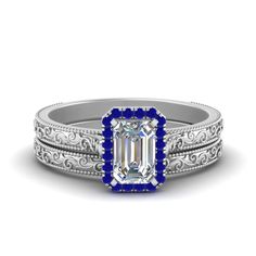 a diamond and blue sapphire engagement ring set with filigrees on the sides