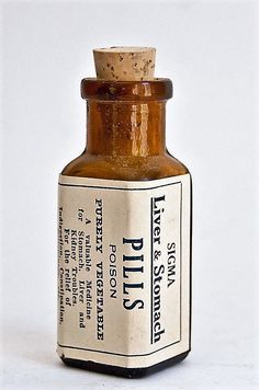 an old medicine bottle sitting on a white surface