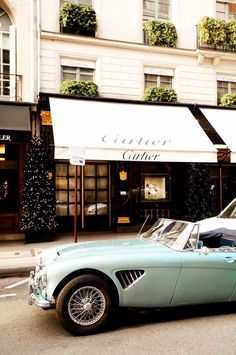 an old car is parked on the street