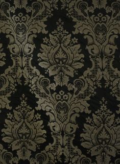 a black and gold wallpaper with an ornate design on the front, in very dark colors