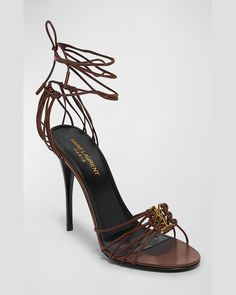 "Find SAINT LAURENT Babylone Strappy Ysl Ankle-tie Sandals on Editorialist. Saint Laurent strappy leather sandals with YSL medallion. 3.50 in / 90 mm stiletto heel. Open toe. Caged vamp and heel. Wraparound ankle ties. Leather lining and outsole. \"Babylone\" is made in Italy." Luxury Leather Strappy Lace-up Sandals, Luxury Strappy Lace-up Sandals For Evening, Luxury Open Toe Lace-up Sandals, Luxury Lace-up Sandals With Heel Strap, Luxury Lace-up Sandals With Ankle Tie For Formal Events, Luxury Leather Sandals With Ankle Tie, Luxury Leather Ankle Tie Sandals, Elegant Brown High Heel Lace-up Sandals, Elegant Brown Lace-up Sandals For Party