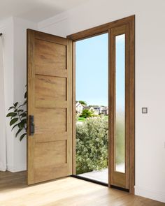 an open wooden door in a white room with wood flooring and plants on the wall