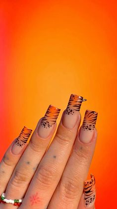 leopard nails tiger nails animal print nails Blue Tiger Print Nails, Nail Art Designs Animal Print, Orange Cheetah Print Nails, Zebra And Leopard Nails, Pink Tiger Print Nails, Tiger Print French Tip Nails, Tiger Nail Art Design, Orange Tiger Nails, Animal Nails Designs