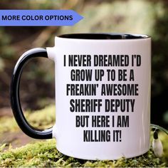 a black and white coffee mug with the words i never dreamed'd grow up to be a freakin'awesome sheriff depty but here i am killing it