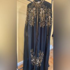 Beautiful Middle Eastern Robe Abaya Dress With Hand Embroidered Flower And Tassel Detail Made In India. Filled With Detail On Front Back And Bottom. One Size Fits All. Long Sets With Intricate Embroidery, Embellished Fitted Long Abaya, Elegant Black Abaya With Floral Embroidery, Traditional Evening Sets With Gold Embroidery, Black Long Kaftan With Dabka Work, Embroidered Evening Kurta With Traditional Drape, Resham Embroidery Abaya For Evening, Fitted Long Abaya For Festive Season, Fitted Long Abaya For Festive Occasions