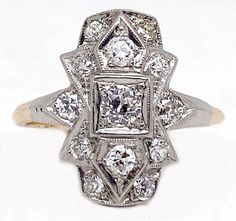 "Vintage Bridal, Art Deco style ring, two-tone.  Beautiful elongated ring with milgrain on top of the mounting. Finely handcrafted with a low profile and a center diamond weighing approximately .25 ct. and approximately .50 ct. total weight in the mounting, average clarity is SI, with Old European cut diamonds. The ring is stamped \"14K\".  Weight is approximately 2.7 grams and the ring size is approximately size 5 ¾.  The condition is very good, it has been polished and is pre-owned. Be sure to check out our shop for matching pieces! Free registered insured shipping on all items in our store!" Formal Art Deco Diamond Ring With Pave Setting, Art Deco Wedding Rings With Pave Setting, Art Deco White Diamond Ring, White Diamond Art Deco Ring, Art Deco White Gold Rings With Pave Setting, Art Deco White Gold Ring With Pave Setting, Art Deco Diamond Ring In Yellow Gold With Accents, Art Deco Diamond Ring With Pave Setting For Anniversary, White Art Deco Diamond Ring With Prong Setting