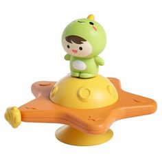 a toy with a green alien sitting on top of it's yellow base,