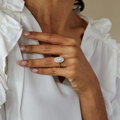 a woman wearing a diamond ring on her finger