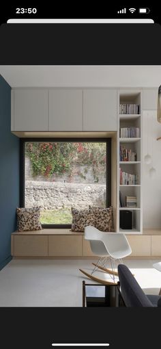 a living room filled with furniture next to a window