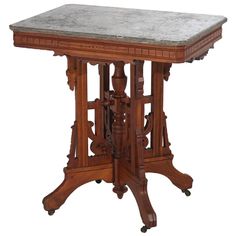 an old wooden table with marble top on wheels and two legs, isolated against a white background