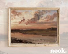 a painting hanging on the wall with clouds in the sky above it and an inscription that reads nook