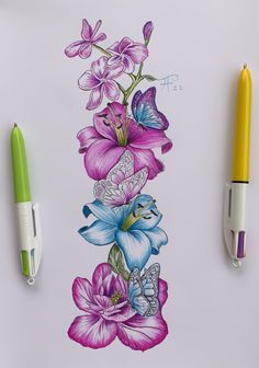 a drawing of flowers and butterflies on a sheet of paper next to two marker pens