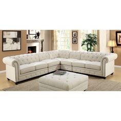 a living room with a sectional couch and ottoman