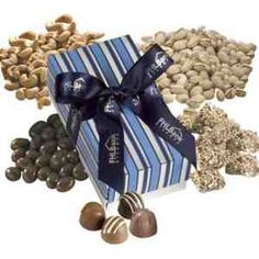 chocolates and nuts are wrapped in a blue striped gift box with a bow on top