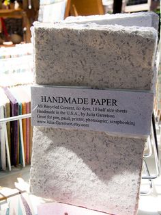 a pile of handmade paper sitting on top of a table next to other books