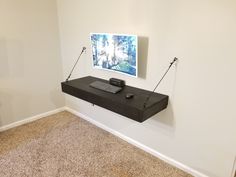 a room with a tv and some wires on the wall next to an empty desk