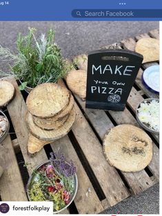 a wooden table topped with lots of different types of pizzas and other food items