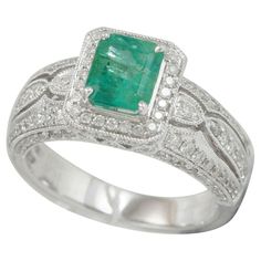 This spectacular ring from the Suzy Levian Limited Edition collection features a Colombian emerald gemstone held in a square shaped 14K white gold prong setting. An array of 138 side white diamonds (.83ct) with hand-carver French filigree work across the band, accents the perfect white gold color of the square cut center stone emerald (0.99ct) The brilliance of these gems and the luster of the high-polish finish of the white gold creates an eye catching piece of jewelry. Jewelry Type: Fine Stone Emerald Band, Emerald And Diamond Ring, Emerald Diamond Ring, Colombian Emeralds, 14k White Gold Ring, Emerald Gemstone, Jewelry Rings Engagement, Cocktail Rings, Emerald Cut