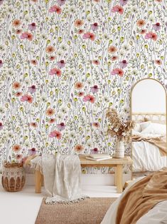 a bedroom with floral wallpaper and a bed in the foreground, next to a mirror