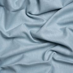 a close up view of a light blue fabric