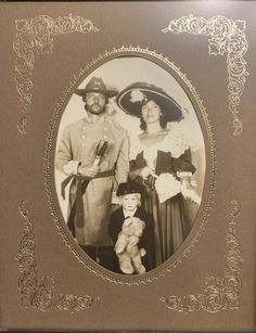 an old photo of two people and a baby