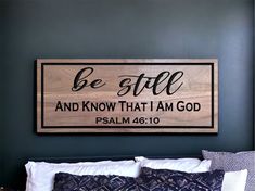 a wooden sign that says be still and know that i am god on the wall