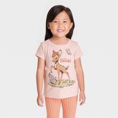 Your child will fawn over this Disney Bambi Short-Sleeve Graphic T-Shirt. The front of this pink pullover tee features an adorable illustration of Bambi, Thumper and a butterfly with the words "Disney Bambi," while the reverse features Flower and two birds. With a crewneck and short sleeves that are perfect for warm weather, the tagless T-shirt is made with a cotton blend that feels comfortable against the skin and is machine washable for easy cleaning. Disney Pink Tops With Cartoon Print, Pink Disney Cartoon Print Top, Pink Disney Cotton Top, Pink Cotton Disney Top, Spring Disney Style Short Sleeve Tops, Nightmare Before Christmas Girl, Bambi Shirt, Bambi Thumper, Adorable Illustration