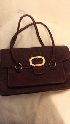 Liz Claiborne Handbag. Burgundy in color, inside pocket, pocket at front and back.  Made of polyvinyl but looks and feels like soft leather.  The bag is 14 x 9 inches. Refer to photos for condition. Formal Rectangular Bags With Pockets, Brown Office Bags With Silver-tone Hardware, Flap Bags With Silver-tone Hardware For Everyday Use, Painted Easter Baskets, Stocking Hanger, Liz Claiborne, Purses And Handbags, Inside Pocket, Soft Leather