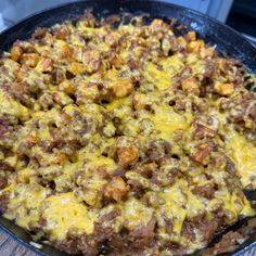 a skillet filled with cheese and meat