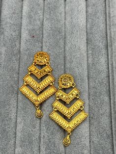 Indulge in the timeless allure of our 24k Polished Nepali Earrings, a true embodiment of elegance and luxury. Meticulously handcrafted by skilled artisans from Nepal, these exquisite earrings are crafted from pure 24k gold, radiating a lustrous and polished finish. The intricate detailing and traditional designs pay homage to Nepal's rich cultural heritage, making each piece a work of art. Elevate your style and make a statement with these opulent Nepali earrings, a perfect accessory for special occasions or adding a touch of glamour to your everyday look. Embrace the beauty of Nepali craftsmanship and adorn yourself with these stunning treasures. Shop now and experience the allure of 24k Polished Nepali Earrings! Next day delivery within uk can be arranged upon request.  We provide worldw Golden Jhumka, Ball Chain Necklace, Gold Baby, Style Earrings, Cultural Heritage, Ball Chain