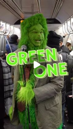 a man in a green suit and hat on a train with the words green one over his head