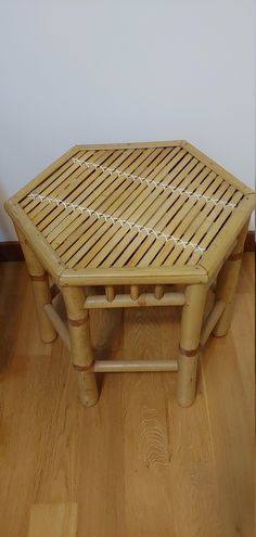 a small wooden table sitting on top of a hard wood floor