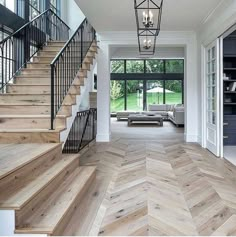 an open floor plan with stairs leading up to the living room