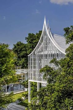 an architecturally designed building surrounded by trees