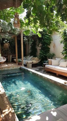 an outdoor swimming pool surrounded by greenery