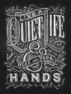 a woman holding up a poster with the words live a quiet life work your hands