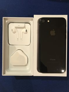 an iphone in its box with ear buds