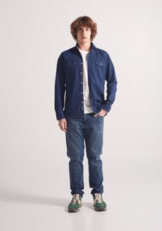 This overshirt is a tough and durable garment made primarily from indigo terracotta dyed cotton. Its design resembles that of a button-down shirt, with chest pockets and rustic stitching details. It is versatile and can be worn open over a T-shirt and jeans for a casual look or paired with more formal pants. 82% cotton 18% Lyocell. Dark blue color. Tagua seed buttons. Button down collar. Two outside pockets. Regular fit. Dark Wash Cotton Shacket For Fall, Rugged Dark Wash Cotton Outerwear, Casual Pre-washed Cotton Outerwear, Indigo Tops With Pockets For Fall, Denim Blue Cotton Shacket With Pockets, Classic Indigo Cotton Denim Jacket, Casual Blue Shacket With Patch Pockets, Indigo Shirt With Pockets For Fall, Medium Wash Cotton Shacket With Pockets