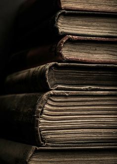 a stack of old books sitting on top of each other