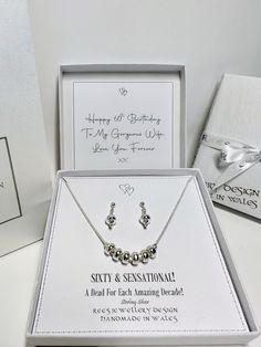 a set of personalized necklaces and matching earrings are on display in a box