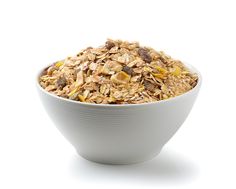 a bowl filled with granola on top of a white table