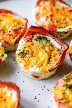 some food that is sitting on a white plate with broccoli and cheese in it