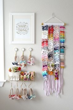 there is a wall hanging with many different items on it and some hooks in the corner