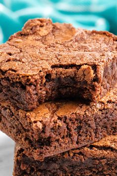 three brownies stacked on top of each other in front of a blue and white background