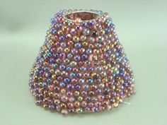 a beaded vase is sitting on a table