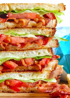 the bacon, lettuce and tomato sandwich is stacked on top of each other