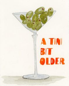 a martini glass with olives in it and the words a tini bit older