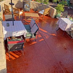 an outdoor patio with tables, chairs and umbrellas