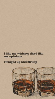 two glasses filled with whiskey sitting next to each other