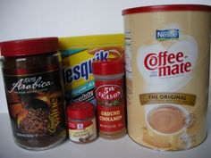 coffee products are lined up next to each other on a counter top in front of a canister